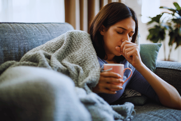 Woman drinking warm herbal medicine for cough